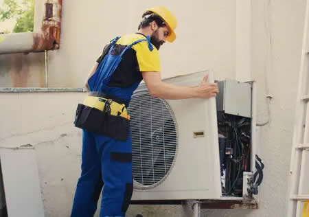  technician servicing ac unit at a Slidell, LA home